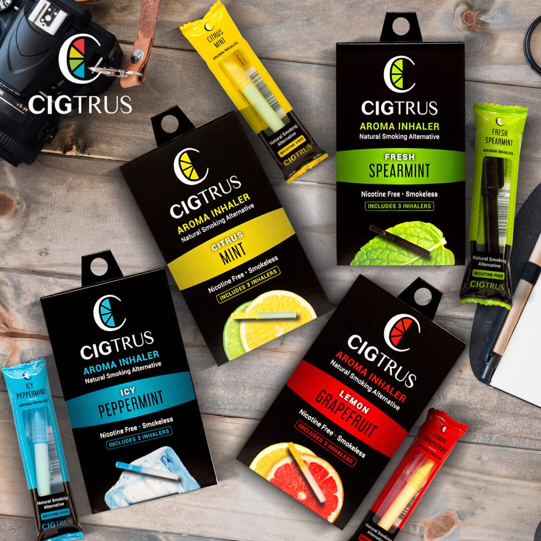 Cigtrus nicotine-free aroma inhalers in citrus, mint, peppermint, spearmint flavors displayed on a wooden surface.