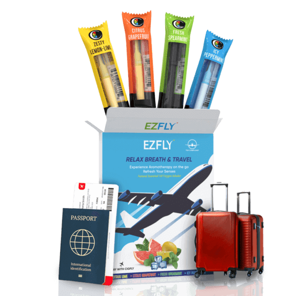 Travel aromatherapy kit with Ezyfly inhalers in citrus, mint flavors, alongside passport, boarding pass, and luggage.