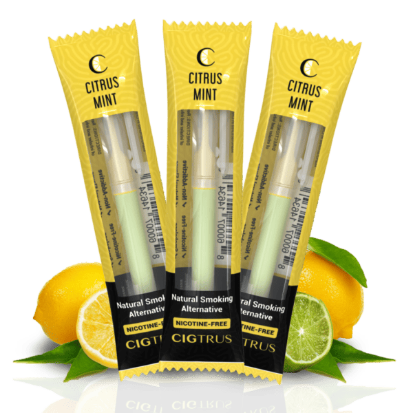 Three lemon-flavored nicotine-free vape pens in yellow packaging with citrus fruits in the background.