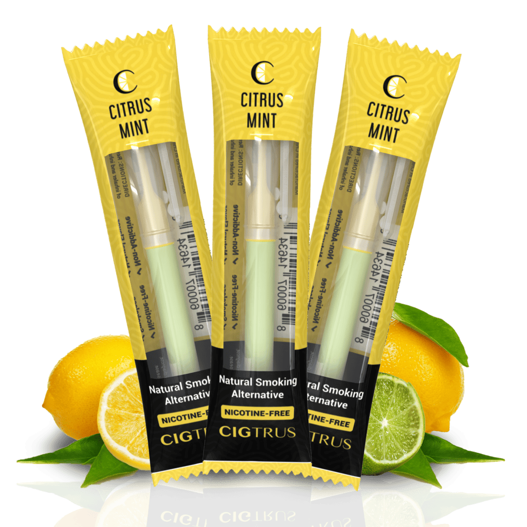 Three lemon-flavored nicotine-free vape pens in yellow packaging with citrus fruits in the background.